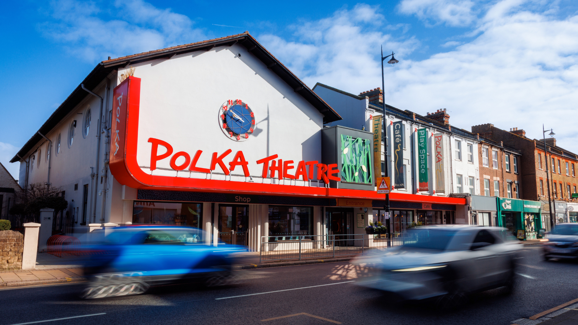 An outside shot of the Polka Theatre building featuring the Polka Theatre logo.