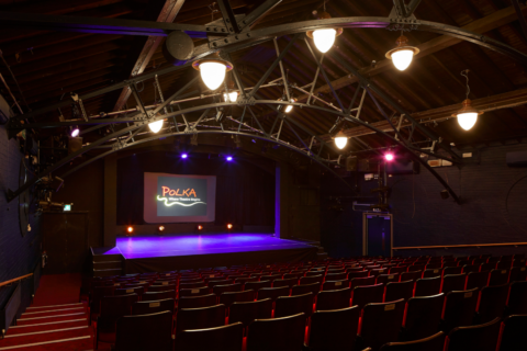 The Polka auditorium empty featuring the logo onstage.