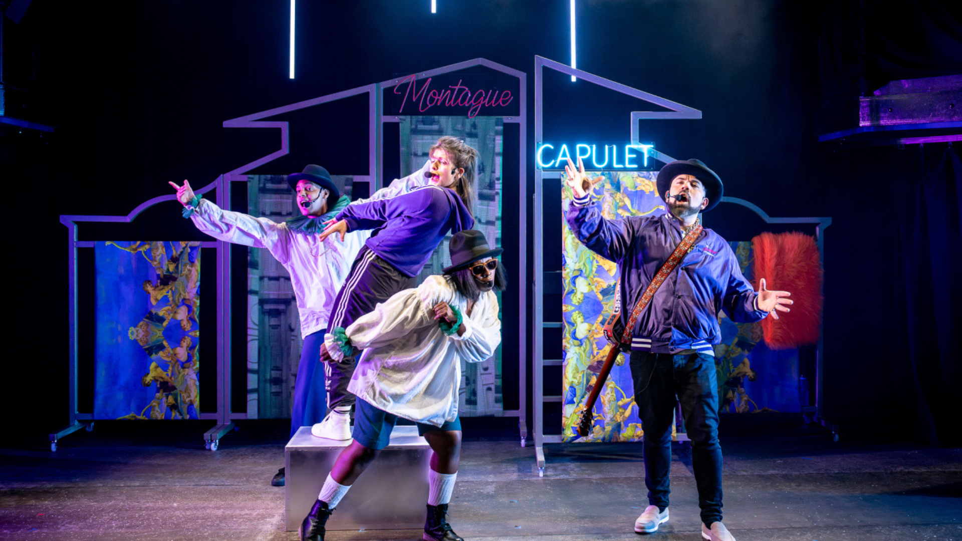 A group of performers on stage during a modern version of Romeo and Juliet.