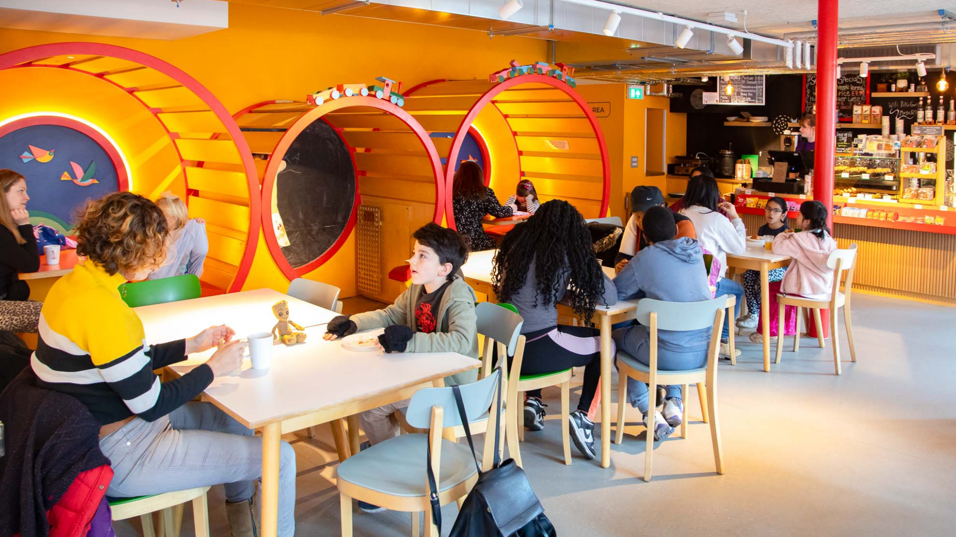 The Polka Cafe full of visitors sat at tables enjoying drinks and conversations.