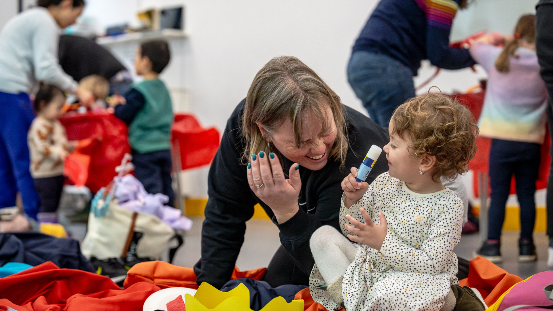 A child and parent laughing together.